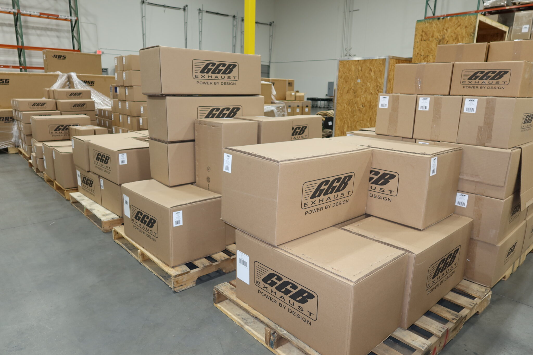 Pallets of Boxes of Aftermarket snowmobile exhaust systems being shipped through a global freight transportation and fulfillment supply chain.