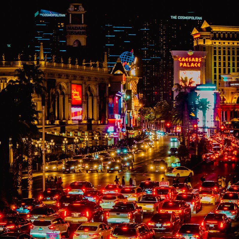 a city street filled with lots of traffic at night