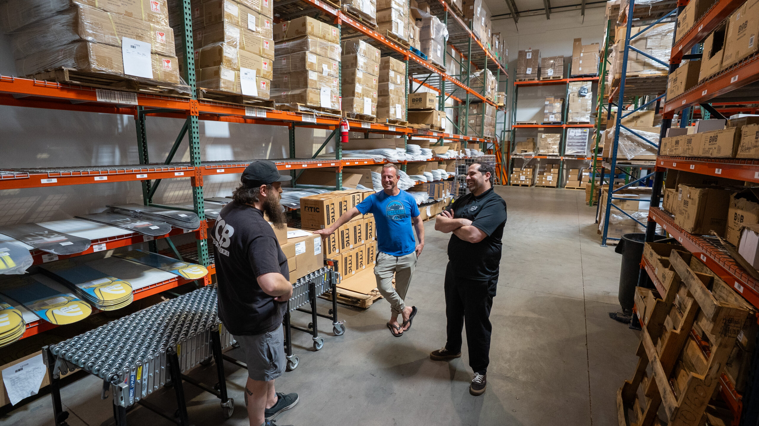 Warehouse workers discussing logistics operations.