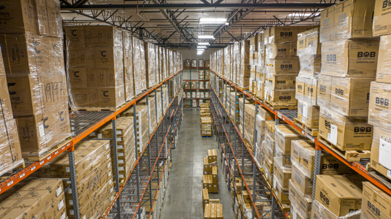 Isles of boxes at one of our warehouses, used in Bi-Coastal Fulfillment Strategy