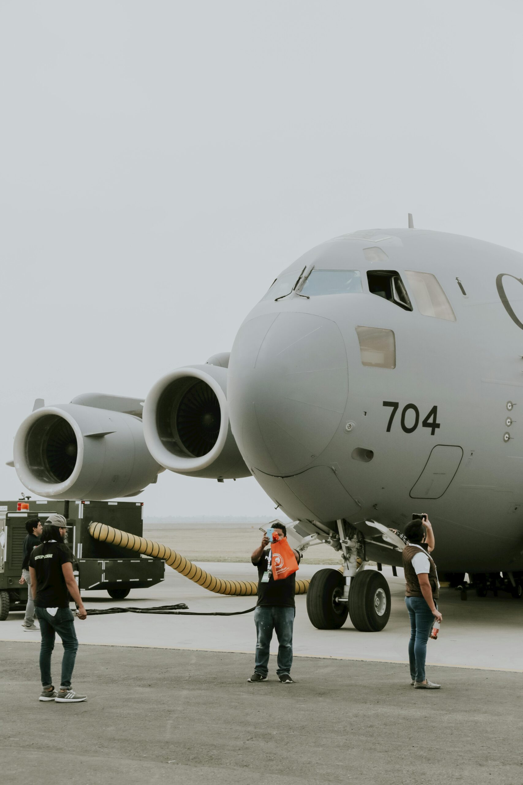 C-17 Globemaster with personnel on the tarmac ready for flight operations.